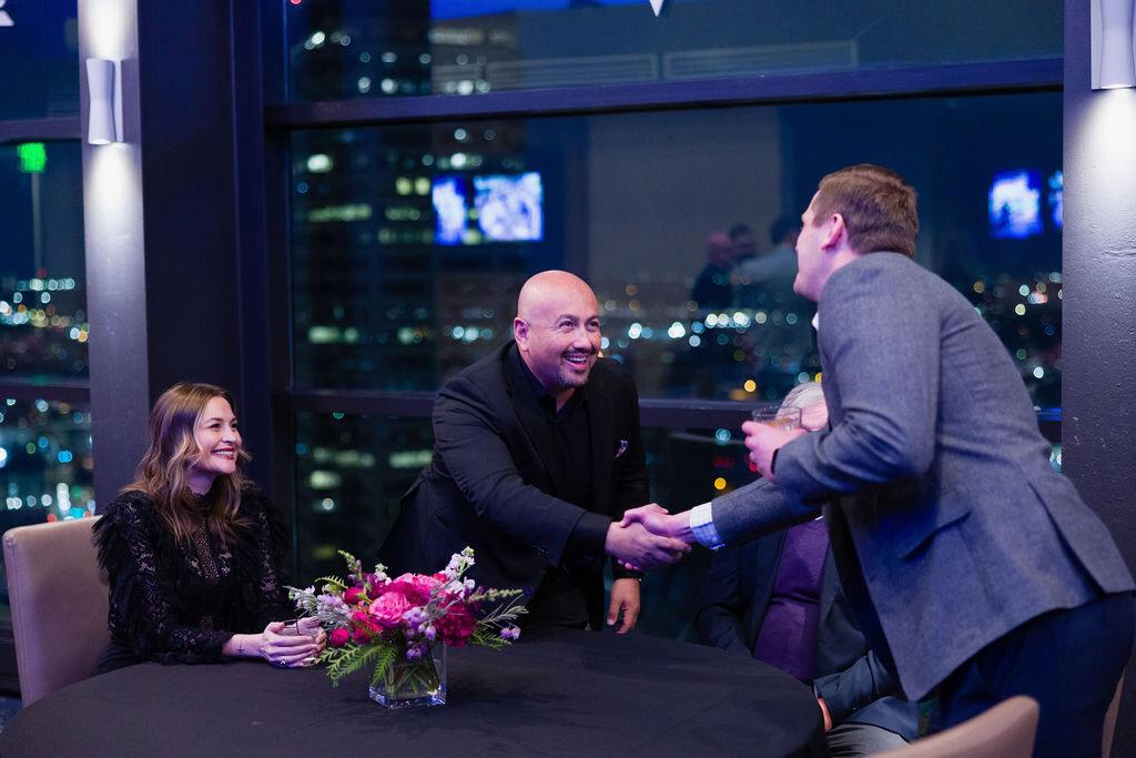Mike Garcia shaking hands with a client